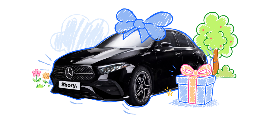 A black Mercedes-Benz with a gift bow, tree and gift box